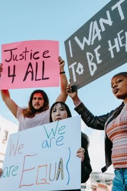 Protestors holding signs about justice and equality